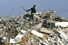 Men of the Salmi family salvage some of the family's belongings from the rubble of their house in the Gaza City neighborhood of Zeitoun, Monday, Jan. 19, 2009. (AP / Lefteris Pitarakis)