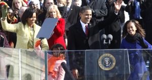 U.S. President Barack Obama, first lady Michelle Obama and their daughters, Malia, right, and Sasha, wave after Obama was sworn in at the U.S. Capitol in Washington, Tuesday, Jan. 20, 2009. (AP / Ron Edmonds)