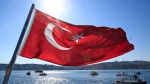 FILE - A Turkish flag flies near the Bosporus strait prior to the Bosporus Cross-Continental Swimming Race in Istanbul, Turkey, Sunday, July 24, 2016. (AP / Lefteris Pitarakis)