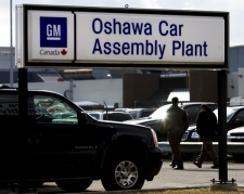 People walk through the parking lot at the General Motors Canada Oshawa Car Assembly Plant in Oshawa, Ont. on Tuesday, Feb. 17, 2009. (THE CANADIAN PRESS / Nathan Denette)