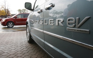 The 25th anniversary edition minivan in the background is parked next to the Chrysler Electric-drive version in Windsor, Ont last year. Over 12 million of the minivans have been sold since its introduction. (Dave Chidley / THE CANADIAN PRESS)