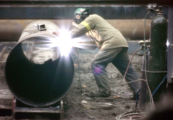 A welder works on a piece of pipe at construction the site in downtown Toronto. A decrease of 43,000 in construction accounted for over half of the employment decline in February. (J.P. Moczulski / THE CANADIAN PRESS)   