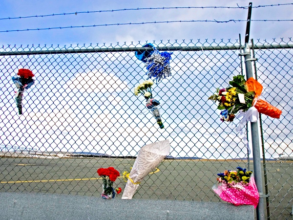 Tribute flower bouquets are seen attached to the fencing outside Cougar Helicopters at the airport in St. John's, N.L. on Saturday, March 14, 2009. (Andrew Vaughan / THE CANADIAN PRESS)