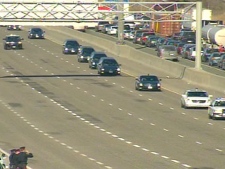 The motorcade carrying the caskets of four fallen soldiers enters eastern Toronto on the Highway of Heroes on Monday, March 23, 2009.