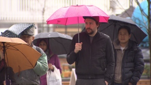 People carry umbrellas in Vancouver on Jan. 28, 2018.