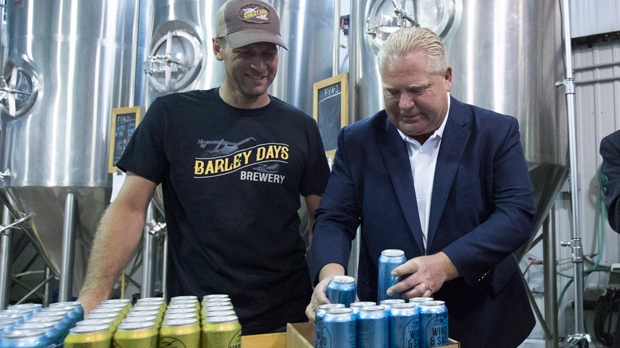 Ontario Premier Doug Ford and Barley Days brewery employee Kyle Baldwin pack some beer before the buck-a-beer plan announcement at Barley Days brewery in Picton, Ont., on Tuesday Aug. 7, 2018. THE CANADIAN PRESS/Lars Hagberg