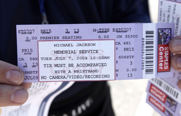 A Dodger Stadium worker holds a ticket for the Michael Jackson memorial is seen in Los Angeles, Monday, July 6, 2009. (AP / Matt Sayles)