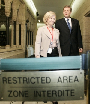 Prime Minister Stephen Harper leaves his office with his press secretary Carolyn Stewart-Olsen as he makes his way to talk to reporters after holding a meeting with his cabinet in Ottawa, Tuesday, March 7, 2006. (Fred Chartrand / THE CANADIAN PRESS)