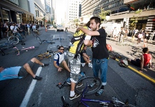 Friends of Darcy Allan Sheppard hug while stopping traffic in protest of their friend`s death at Bloor and Bay streets in Toronto on Tuesday, September 1, 2009.(THE CANADIAN PRESS/Darren Calabrese)