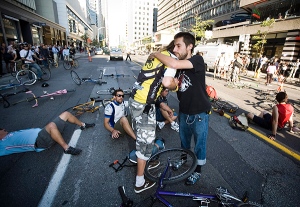 Friends of Darcy Allan Sheppard hug while stopping traffic in protest of their friend`s death at Bloor and Bay streets in Toronto on Tuesday, September 1, 2009.(THE CANADIAN PRESS/Darren Calabrese)