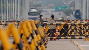 South Korean army soldiers stand near barricades at the Unification Bridge, which leads to the Panmunjom in the Demilitarized Zone (DMZ), in Paju, South Korea, Thursday, June 18, 2020. (AP Photo/Lee Jin-man)