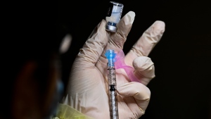 Francesca Paceri, a registered pharmacist technician carefully fills the Pfizer-BioNTech COVID-19 mRNA vaccine at a vaccine clinic during the COVID-19 pandemic in Toronto on Tuesday, December 15, 2020. Toronto and Peel region continue to be in lockdown. THE CANADIAN PRESS/Nathan Denette