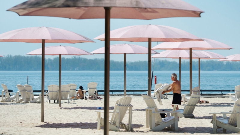 People practice physical distancing as they enjoy the hot weather at Sugar Beach during the COVID-19 pandemic in Toronto on Tuesday, May 26, 2020. THE CANADIAN PRESS/Nathan Denette