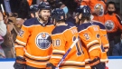 Edmonton Oilers' Brendan Perlini (42), Derek Ryan (10) and Duncan Keith (2) celebrate a goal against the Columbus Blue Jackets during second period NHL action in Edmonton on Thursday, December 16, 2021.THE CANADIAN PRESS/Jason Franson 