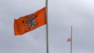 The Canadian flag hangs half-mast as a ceremonial flag is raised to honour victims of the Canadian Indian residential school system during the Xe xe Smun’ eem-Victoria Orange Shirt Day Every Child Matters ceremony to honour while at Centennial Square in Victoria, B.C., on Thursday, September 30, 2021. THE CANADIAN PRESS/Chad Hipolito 