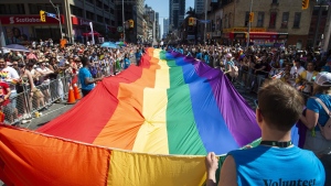 Volunteers with Pride Toronto carry a large rainbow flag during the 2019 Pride Parade in Toronto, Sunday, June 23, 2019. THE CANADIAN PRESS/Andrew Lahodynskyj