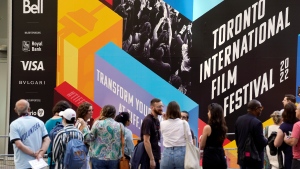 Festival attendees wait in line for a screening of the Swedish film "Triangle of Sadness" on day one of the 2022 Toronto International Film Festival, Thursday, Sept. 8, 2022, in Toronto. The 47th annual film festival runs through Sept. 18. (AP Photo/Chris Pizzello)