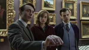 This image released by Amazon shows, from left, David Dawson, Emma Corrin and Harry Styles in a scene from "My Policeman." (Parisa Taghizadeh/Amazon via AP)