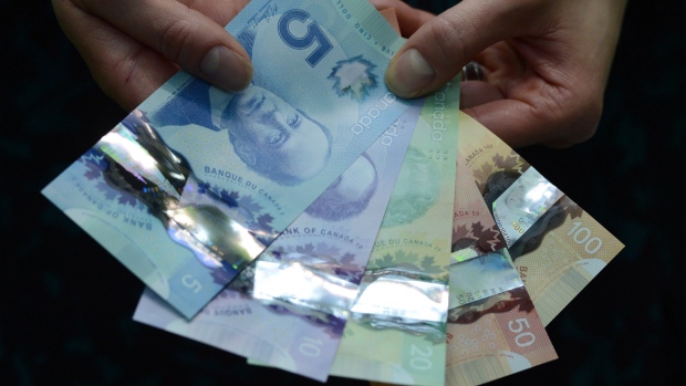 A representative with the Bank of Canada displays the polymer $5 and $10 bank notes alongside the $20, $50, and $100 during a press conference at the Bank of Canada in Ottawa on Tuesday, April 30, 2013. THE CANADIAN PRESS/Sean Kilpatrick