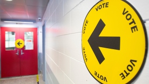 File photo: An arrow points to where people can go to cast their ballots on federal election day in Montreal, Monday, Sept. 20, 2021. THE CANADIAN PRESS/Graham Hughes 