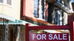 A real estate sign is displayed in front of a house in the Riverdale area of Toronto on Wednesday, September 29, 2021. THE CANADIAN PRESS/Evan Buhler 