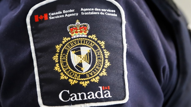 A Canada Border Services Agency patch is seen on an officer in Calgary, Alta., Thursday, Aug. 1, 2019. The Canada Border Services Agency says it was part of an international effort that led to two Montreal-based companies being added to a United States sanctions list for their alleged ties to the Russian military. THE CANADIAN PRESS/Jeff McIntosh