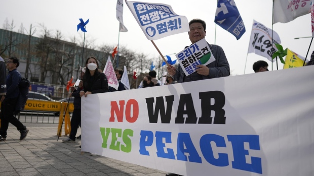 Protesters hold signs