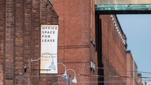 Signage displaying office spaces for lease hangs from a building in Toronto's Liberty Village on Tuesday, March 9, 2021. THE CANADIAN PRESS/Tijana Martin
