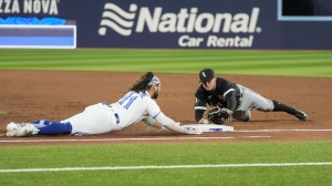 Cavan Biggio of the Toronto Blue Jays looks on from first base