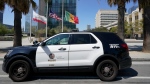 FILE - A Los Angeles Police Department vehicle is parked outside the LAPD headquarters downtown Los Angeles on July 8, 2022. A Los Angeles police sergeant and five officers broke department policy when they opened fire in 2022 on an armed man who refused to follow officers' commands, killing him, a police commission found. (AP Photo/Damian Dovarganes, File)