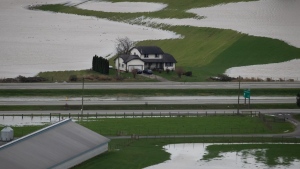 house above flooded B.C. farmland