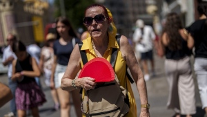 woman fans herself in Madrid, Spain