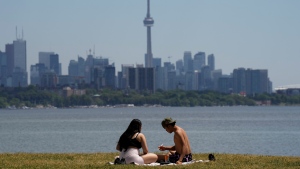 People eat lunch on a hot day in Toronto on Thursday, June 23, 2022. THE CANADIAN PRESS/Nathan Denette 