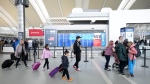 People are shown at Pearson International Airport in Toronto on Friday, March 10, 2023. THE CANADIAN PRESS/Nathan Denette