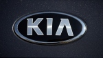 The company logo shines off the hood of a 2021 K5 sedan on display in the Kia exhibit at the Denver auto show Friday, Sept. 17, 2021. (AP Photo/David Zalubowski)