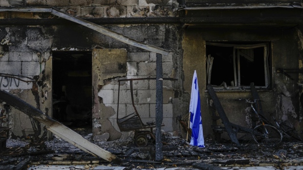 Israeli flag next to destroyed house