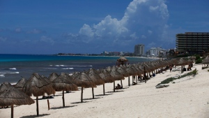FILE - Tourists enjoy the beach before the arrival of Hurricane Grace, in Cancun, Quintana Roo State, Mexico, Wednesday, Aug. 18, 2021. (AP Photo/Marco Ugarte) 