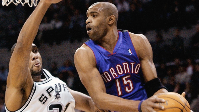 Toronto Raptors' Vince Carter (15) maneuvers past San Antonio Spurs' Tim Duncan during the first quarter at the SBC Center in San Antonio Wednesday, Dec. 17, 2003.(AP Photo/Doug Sehres)