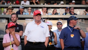 Republican presidential candidate former President Donald Trump, centre, stands on the 18th hole green as he watches the final round of LIV Golf Miami, at Trump National Doral Golf Club, Sunday, April 7, 2024, in Doral, Fla. (AP Photo/Rebecca Blackwell) 