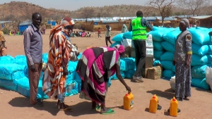 Sudanese refugees displaced by the conflict in Sudan gather to receive food staples from aid agencies at the Metche Camp in eastern Chad on Tuesday, March 5, 2024. AP/Jsarh Ngarndey Ulrish