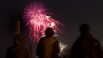 FILE - People watch the Toronto Victoria Day fireworks on the beach on Monday, May 20, 2013. THE CANADIAN PRESS/Chris Young 