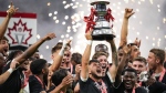 Vancouver Whitecaps' Ryan Raposo hoists the Voyageurs Cup after Vancouver defeated CF Montreal 2-1 during the Canadian Championship soccer final, in Vancouver, on Wednesday, June 7, 2023. Toronto FC will play Canadian Premier League champion Forge FC in one Canadian Championship semifinal with the defending champion Vancouver whitecaps taking on ether CPL's Pacific FC or Atletico Ottawa in the other. THE CANADIAN PRESS/Darryl Dyck