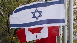 The flags of Canada and Israel fly at half mast on Wednesday, October 11, 2023 in Ottawa. THE CANADIAN PRESS/Adrian Wyld