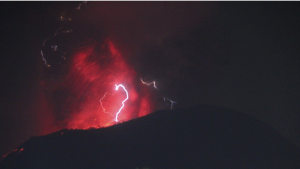 In this photo video released by Indonesia's Geological Agency of the Ministry of Energy and Mineral Resources (Badan Geology), the night sky glows as Mount Ibu spews volcanic materials during an eruption on Halmahera Island, Indonesia, Thursday, June 6, 2024. (Badan Geologi via AP)