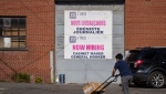 A "Now Hiring," sign is displayed on a business Tuesday, May 30, 2023 in Montreal. THE CANADIAN PRESS/Christinne Muschi
