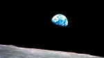 FILE - This Dec. 24, 1968, file photo made available by NASA shows the Earth behind the surface of the moon during the Apollo 8 mission. Retired Maj. Gen. William Anders, the former Apollo 8 astronaut who took the iconic “Earthrise” photo showing the planet as a shadowed blue marble from space in 1968, was killed Friday, June 7, 2024, when the plane he was piloting alone plummeted into the waters off the San Juan Islands in Washington state. (William Anders/NASA via AP, File) 