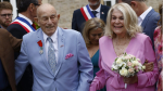US WWII veteran Harold Terens, 100, left, and Jeanne Swerlin, 96, arrive to celebrate their wedding at the town hall of Carentan-les-Marais, in Normandy, northwestern France, on Saturday, June 8, 2024. (AP Photo/Jeremias Gonzalez)