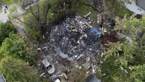 Investigators and firefighters remain on the scene at the 23500 block of North Overhill Road, after an explosion destroyed a home in unincorporated Lake Zurich, Ill., Wednesday, June 5, 2024.  (Paul Valade/Daily Herald via AP)