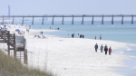 People walk along the shoreline in Navarre Beach, Fla., on Wednesday March 27, 2013.  (Nick Tomecek/Northwest Florida Daily News via AP)