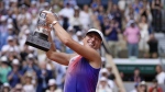 Poland's Iga Swiatek holds the trophy after winning the women's final of the French Open tennis tournament against Italy's Jasmine Paolini at the Roland Garros stadium in Paris, France, Saturday, June 8, 2024. (AP Photo/Thibault Camus)